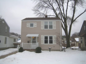 The menacing branches of the neighbor's ash tree threaten to overwhelm the simple pine frame of the Larson residence.