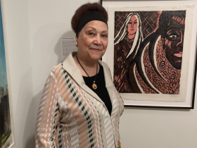 Frieda High Wasikhongo Tesfagiorgis in front of her 1968 woodcut Untitled. Photo by Michael Horne on Sept. 24, 2026.