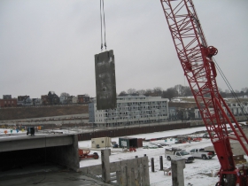 Precast concrete panel being lifted into place