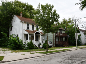 Privately-Owned Homes on 25th St. With City-Owned Home Covered By Tree