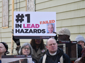 Sign at Common Ground Crowd at Highgrove Holdings Press Conference