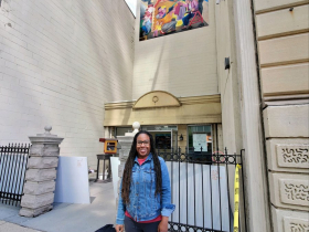 Tia Richardson In Front of Her Grand Avenue Club Mural