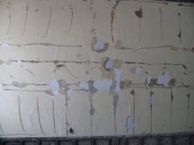 Old plaster walls show years of painting and repainting