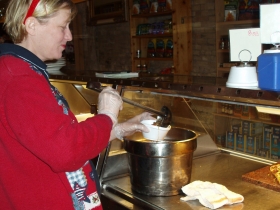 Dawn Andrade Ladling Soup. Photo by Peggy Schulz.