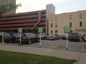 Three new ZipCar spots, located in the parking lot at the corner of Broadway and Michigan St. Photo by Mariiana Tzotcheva.