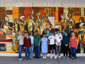 Three generations of Cathonys posing in front of “Dad’s” mural at 803 W. Michigan St.