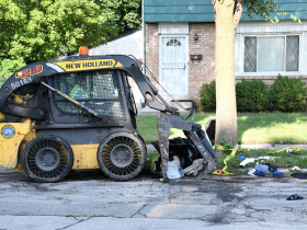 Skid Steer Picking Up Flood Debris