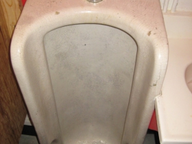 This monumental floor-mounted urinal dates to the first years of manufacture of such an appliance.
