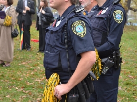 Local MPD officers keep watch and enjoy the celebration, pom poms and all.