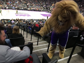 Kings; mascot Slamson attempts to give a young fan five during the game.