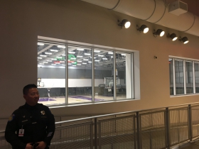 A security guard watches over the Kings practice courts which are visible from the arena concourse.