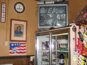 We've got a cooler, a tv, a bunch of snacks and a nice pastel portrait of Winky overlooking his favorite spot at the bar. The blue and white checkerboard ceiling treatment is a bold aesthetic leap.