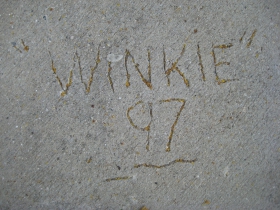 Winkie is memorialized in a concrete engraving by the front door.