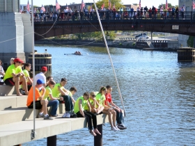Teammates View the Race from the Manpower Riverwalk