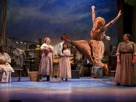 Christal Wagner (Gertie Cummings), center, dances around the cast of Skylight Music Theatre’s production of Oklahoma! September 27 – October 13.