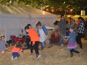 Children play in the straw at Harvest Fair 2019
