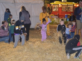 Children play in the straw at Harvest Fair 2019