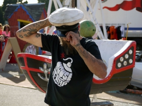 To set up the boat of the Life Size Game of Mousetrap, this crew member dons his admiral hat