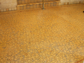 Valencia Mosaic bordered with deco tiles welcome coziness and warmth to the elegant Embassy Apartments on Prospect Ave.