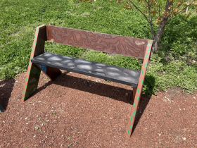 'Unearthed' is the bench painted by ArtWorks for Milwaukee lead artist assistants Sydney Eserkaln, Lily Gruenewald, and Mitchell Liebhauser.