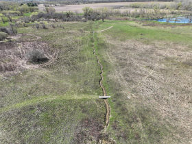 The Briggs Wetland ditch with East Branch of Raccoon River beyond in April 2024