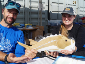 Riveredge staff Matt Smith and Anna Jean Hallmann hold a plush sturgeon toy at Harbor Fest 2023