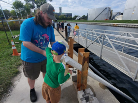 Jeff Mercer helps his son Lucas release a sturgeon down the halfpipe and into the Milwaukee harbor slip on Sept. 24, 2023