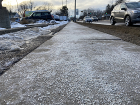 Salt carpets the sidewalk along Willy Street in Madison, Wis. in February 2022