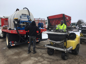 The Bruce Company in Middleton, Wis. loads brine from the tanker truck into the sidewalk units