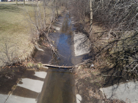Wahl Creek looking north from a Glendale Avenue bridge over the channelized waterway as it flows along the east edge of Harriet Tubman Park south toward Lincoln Creek