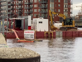 Area of Concern dredging in the Milwaukee River in the Third Ward in April 2023