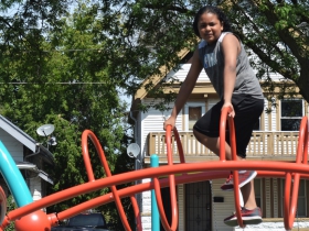 A child climbs the new play structure at Columbia Playfield