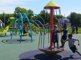 Children play at Columbia Playfield on the day of its reopening