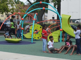 Children play at Columbia Playfield on the day of its reopening