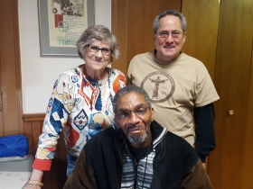 Cary (L) and Chuck (R) with Capuchin Community Services' guest, Craig, who was just fitted with new eyeglasses.