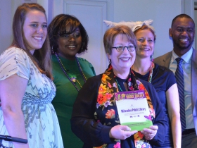 City Librarian Paula Kiely accepts UEDA's Bridge Builder Award at Carnival Milwaukee