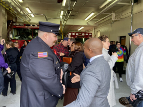 Firefighter Brian McMenamin speaks with Mayor Cavalier Johnson