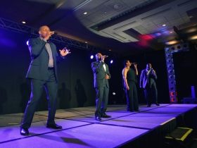 The military quartet,Voices of Service, performed at the Grand Slam Charity Jam.