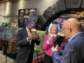 County Executive David Crowley, Supervisor Anne O'Connor and Sprecher President and CEO Sharad Chadha sip a beer at the 2026 Traveling Beer Garden announcement
