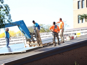 The great weather continued all week as participants in the Great Lakes Community Conservation Corps (GLCCC) program (in blue shirts) assisted Arch Electric with the panel installation.