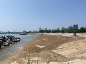 Sand piles pushed closer to breakwater