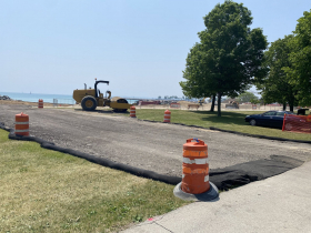An asphalt strip has been constructed for trucks hauling sand onto the beach