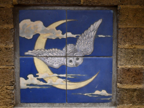 Faience tiles illustrate owls on the fireplace in a kindergarten room at Keefe Elementary.