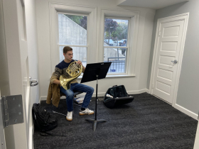 An MSOE student plays the french horn at the Patricia E. Kern Conservatory of Music.