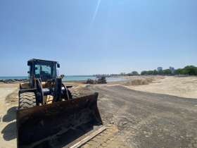 A front end loader sits idle at McKinley Beach