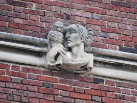 Some versions of owls show one perched on Athena’s hand, like at Roosevelt Middle School, in carved Bedford limestone in 1924.