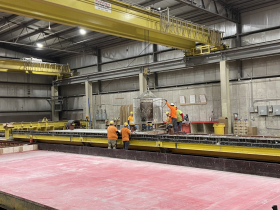 Stonecast workers pouring and smoothing a panel.