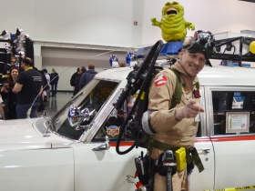 west-central-wisconsin-ghostbuster-poses-in-front-of-ectomobile