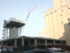 The elevator tower can be seen rising over the construction.