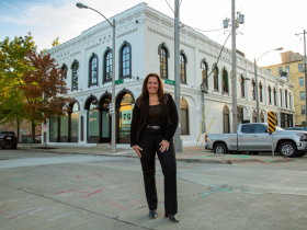 Anne Zizzo in front of new HQ